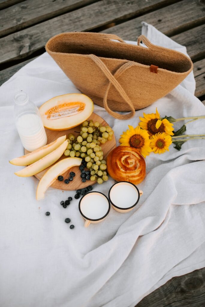 a wooden table topped with a bag and a bunch of food